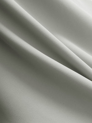 Close-up texture of silver gray flat front golf joggers pants with belt loops fabric showing detailed material and weave.