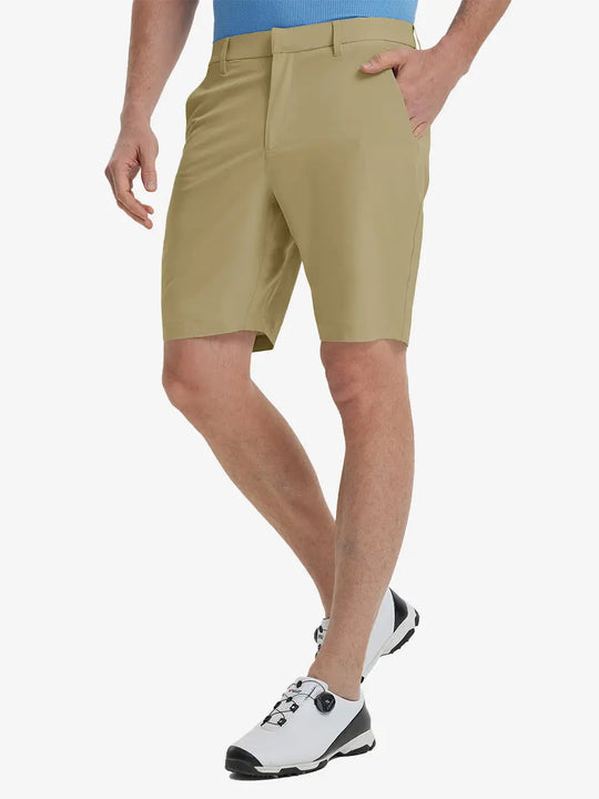 Front view of model’s lower body with hands in pockets, wearing Player Fit Versatile Solid Shorts 9 Inch – KHAKI