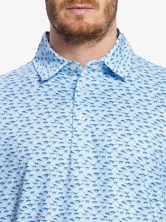 Front half-body view from nose to chest of model wearing BLUE DINOSAUR Performance Quick Dry Print Golf Polo.