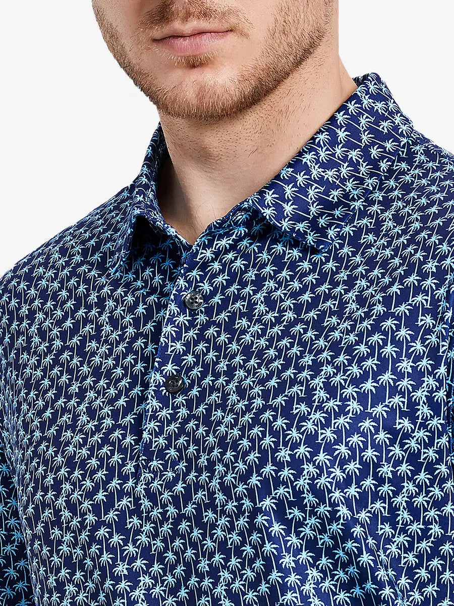 Navy blue polo shirt with tropical palm print brings summer vacation style for multi-occasion wear.