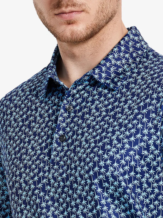 Navy blue polo shirt with tropical palm print brings summer vacation style for multi-occasion wear.