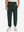 Model wearing forest green fleece stretch water resistant boys joggers, front view showing lower body and pants.