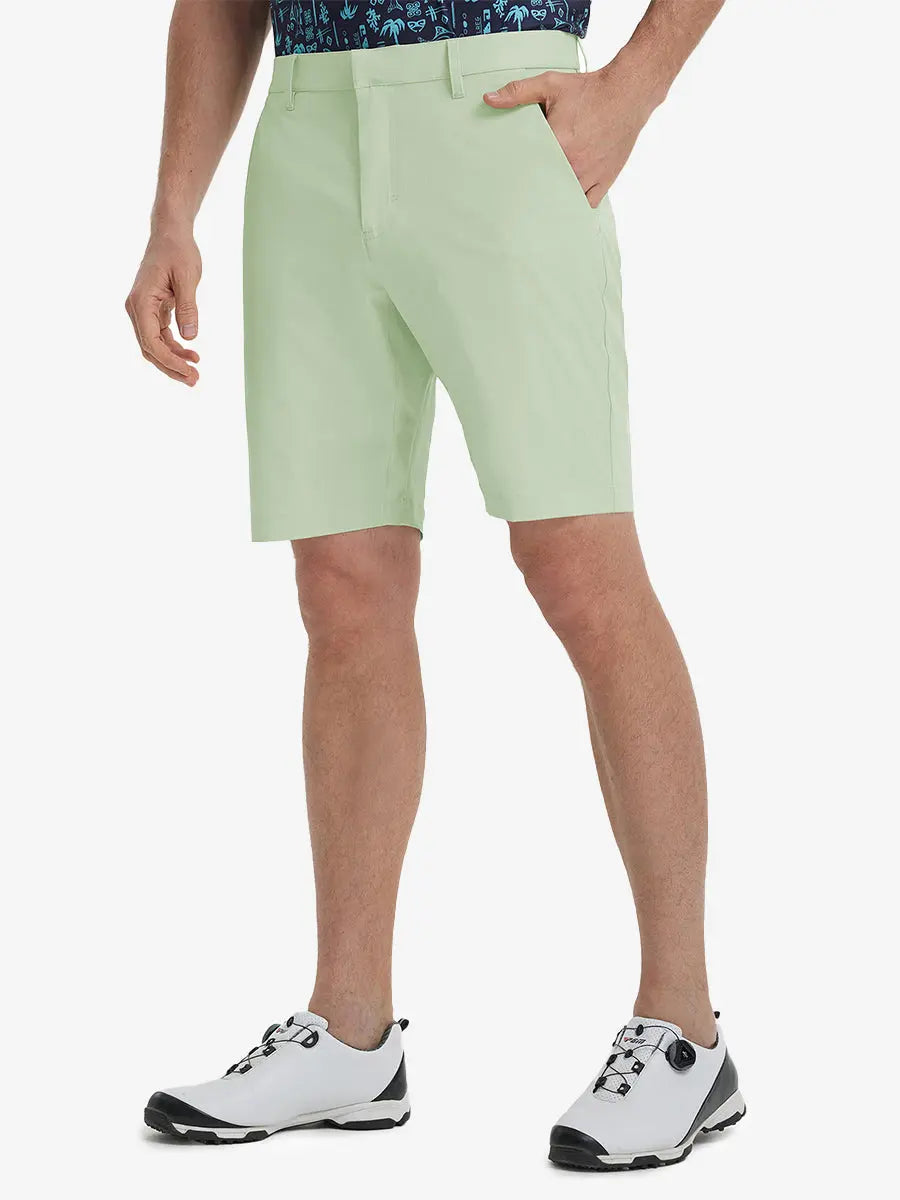 Front view of model’s lower body with hands in pockets, wearing Player Fit Versatile Solid Shorts 9 Inch – LIGHT GREEN