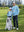 A full-body shot of a model wearing a youth full print stylish hoodie pullover in blue ethnic, with his dad.