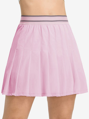 Front lower body shot of model wearing light pink women's moisture-wicking athletic tennis skirts