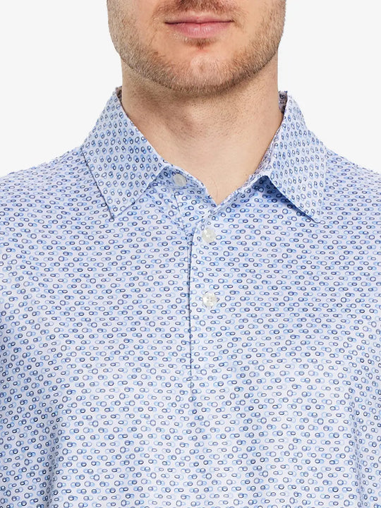 Front half-body view from nose to chest of model wearing BLUE LOOP CHAIN Performance Quick Dry Print Golf Polo.