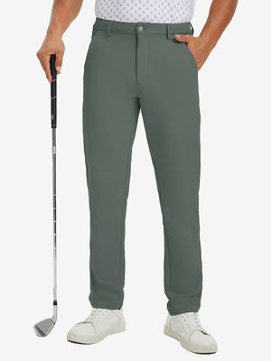 Lightweight moisture wicking dress pants in slate green, front lower-body with model leaning on golf club.