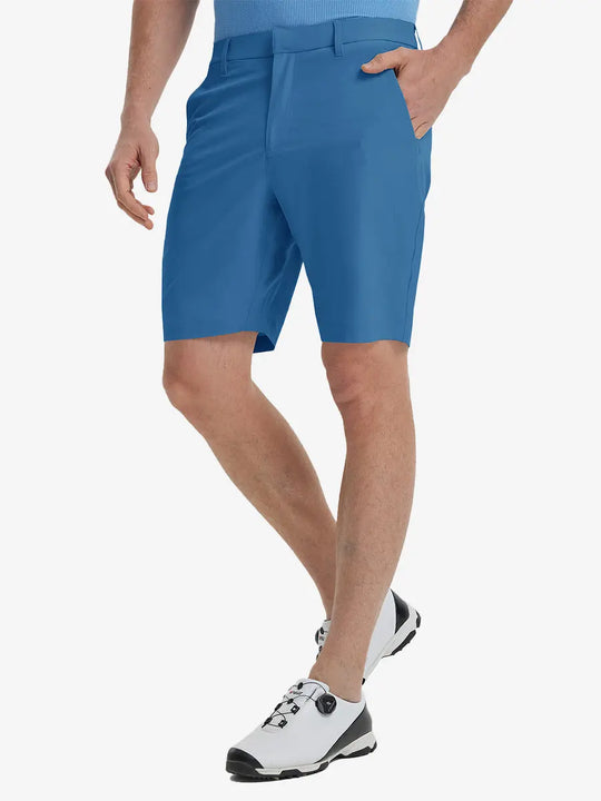 Front view of model’s lower body with hands in pockets, wearing Player Fit Versatile Solid Shorts 9 Inch – BLUE