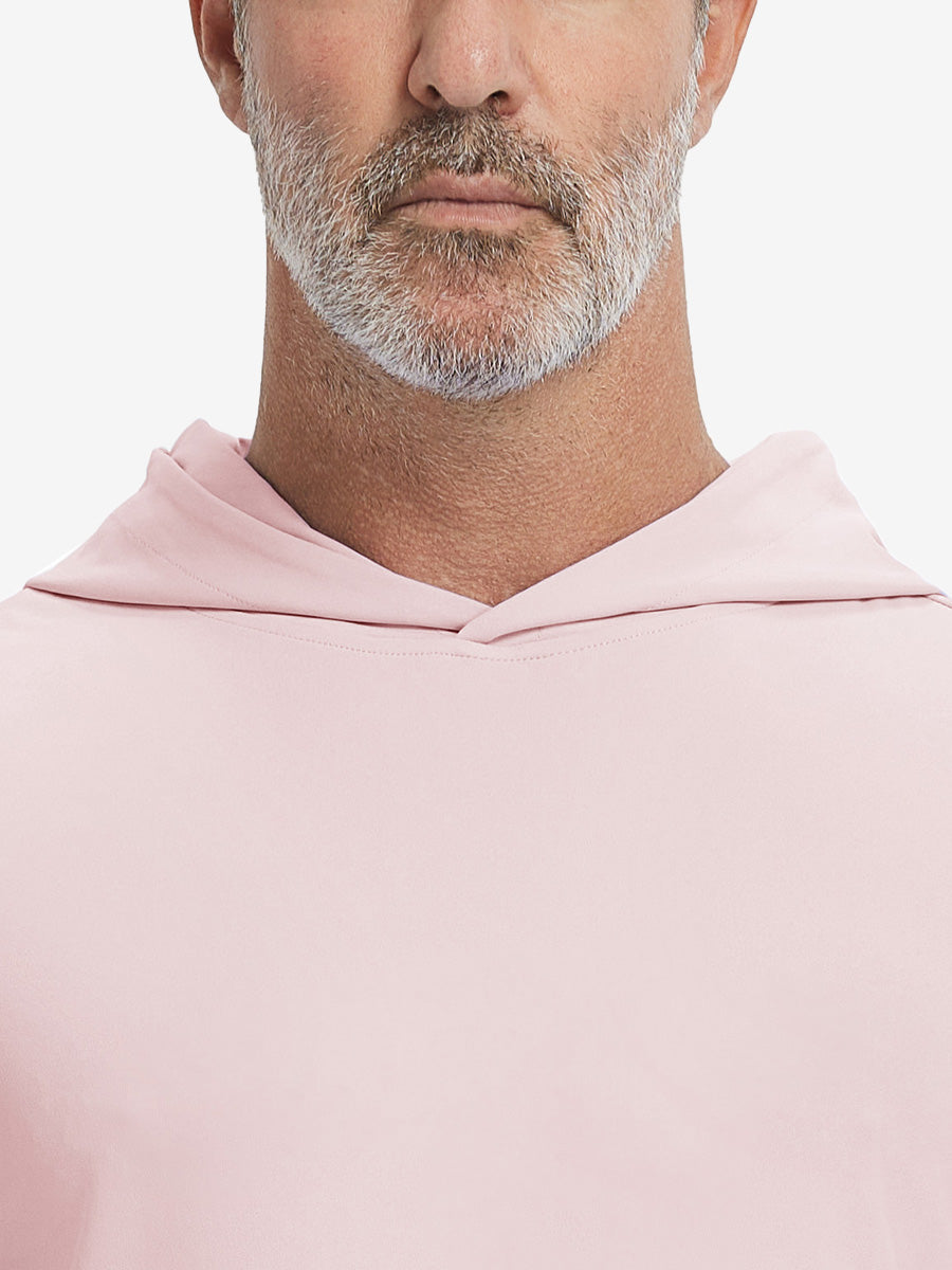 Close-up from nose to chest, showing soft collar texture and stitching detail of the light pink hoodie.