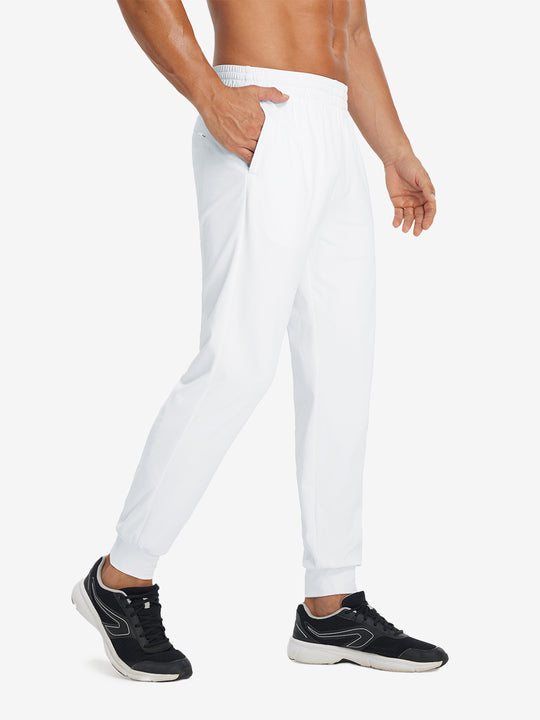 Side view of model with hand in pocket wearing lightweight traning track pants in white.