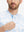 Close-up: nose to chest in sky blue camo stretch printed collarless henley golf shirts