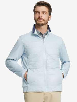 Front view of model with both hands in side pockets, wearing Golf Fleece Winter Jacket in Glacier Grey.