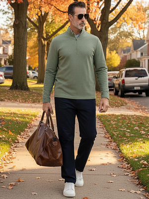 Texture heather fleece lined 1/4 zip pullover in greem, walking on path with leather bag and sunglasses