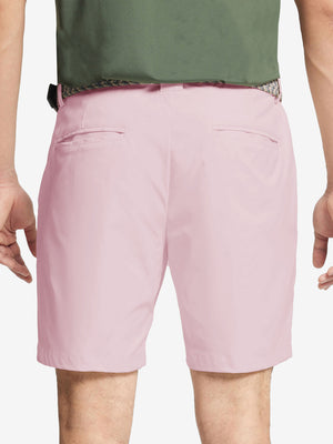 Back waist to knee view of pink water resistant golf 7 inch shorts, flexible performance fit.