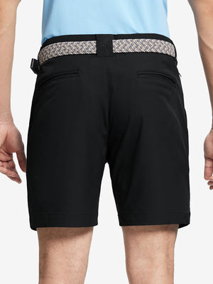 Back waist to knee view of black water resistant golf 7 inch shorts, flexible performance fit.