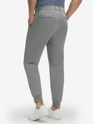 Back lower body shot of model wearing iron grey flat front golf joggers pants with belt loops