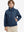 Boys windproof puffer jacket with pockets in dark blue, model front upper-body with one hand in pocket.