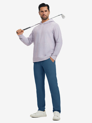 Model holding a golf club on shoulder, wearing blue indigo water-resistant golf stretch nylon pants.