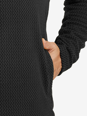 Close-up of pocket detail on midweight warm stretchy quarter zip pullover in black, showing neat stitching.