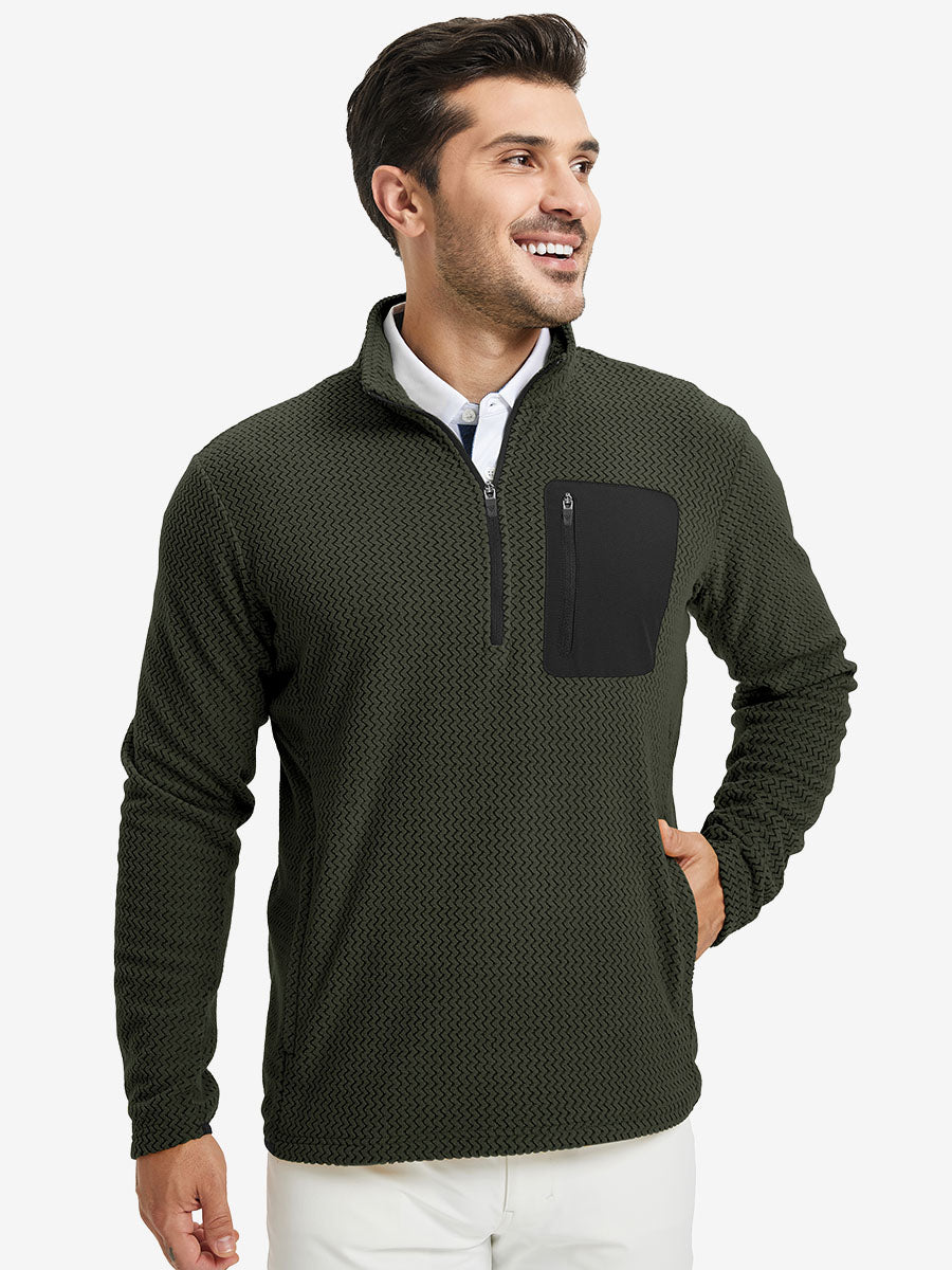 Model with one hand in side pocket, wearing midweight warm stretchy quarter zip pullover in forest green.