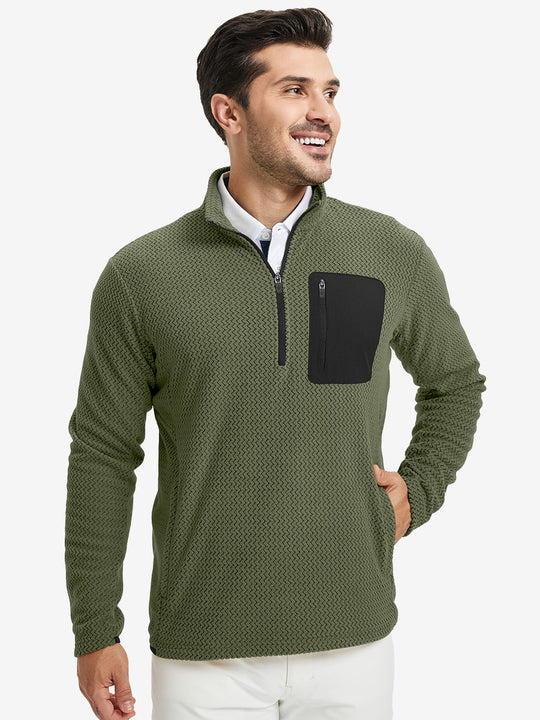 Model with one hand in side pocket, wearing midweight warm stretchy quarter zip pullover in green.
