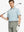 Front half-body shot holding golf club in Haze Blue White Yarn Dyed Stripe Polo – breezy and modern