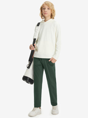 Boys Stretch Fleece Lined Casual Golf Pants in forest green, model front view carrying tennis bag