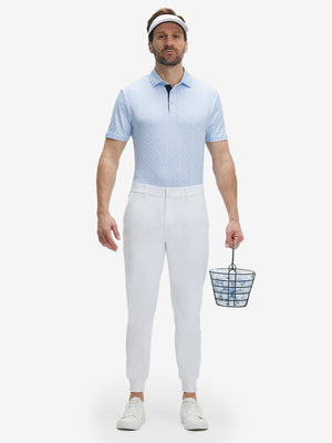Front full body shot of model wearing white flat front golf joggers pants with belt loops