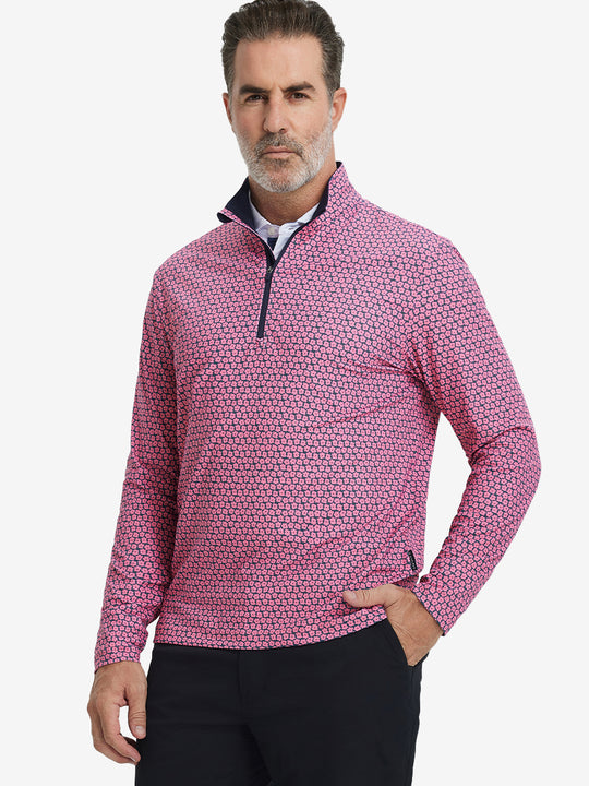 Front upper body view of model standing in red navy flower full print quarter zip pullover, relaxed look.