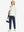 Boys Stretch Fleece Lined Casual Golf Pants in navy, model front view carrying tennis bag