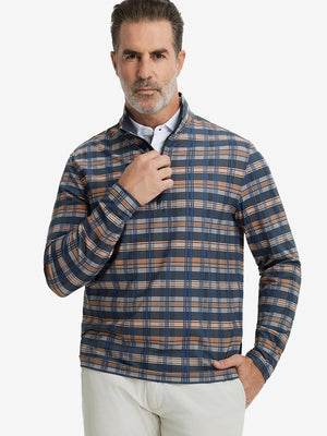 Front upper body view of model standing in blue/white/yellow plaid full print quarter zip pullover, relaxed look.