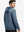 Back upper body view of the navy melange classic heather hoodie, model turns head slightly with ease.