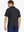 Back half-body view of model wearing BLACK Elegant Performance Jacquard Polo