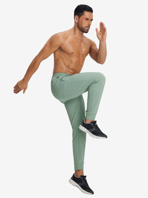 Back lower body view showing beryl green soft sweatpants with 4 zipper pockets