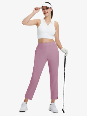 Full-body front view wearing golf hat and holding club in PINK Women's 7/8 Ankle Golf Track Pants.
