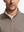 Front shot from nose to chest of model wearing brown melange  lightweight sleeveless quarter zip golf vest