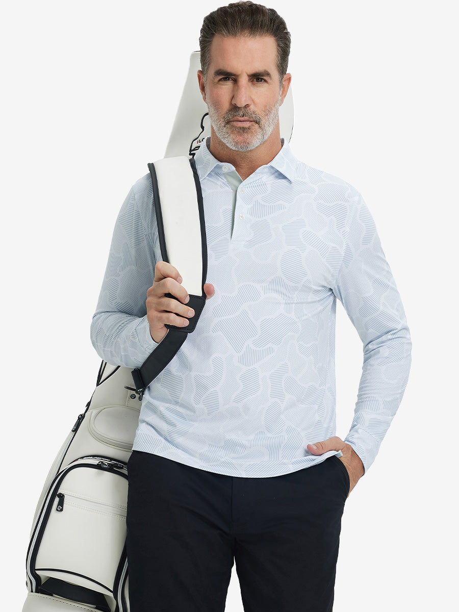Model carrying golf bag, styled in light gray irregular pattern lightweight print long sleeve polo, sleek golf outfit.