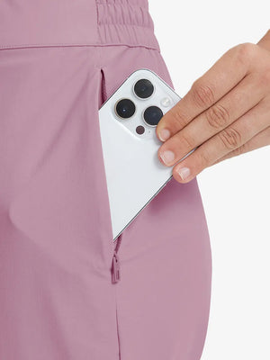 Detail shot of front side pocket holding an iPhone in PINK Women's 7/8 Ankle Golf Track Pants.