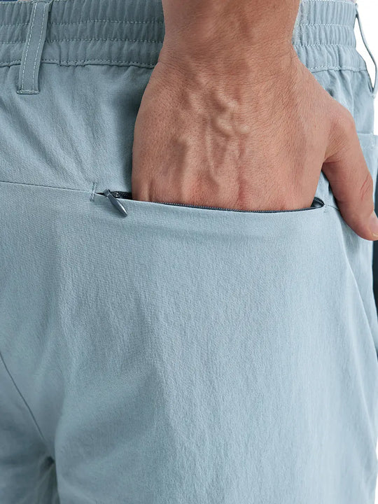 Back view of Performance Water Resistant Pants in POWDER BLUE，model’s hand casually in back pocket.