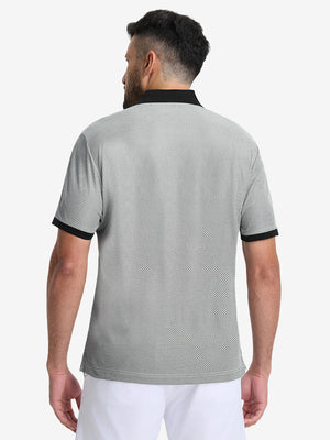 Back half-body shot of model wearing the black quick dry jacquard ribbed collar golf shirt