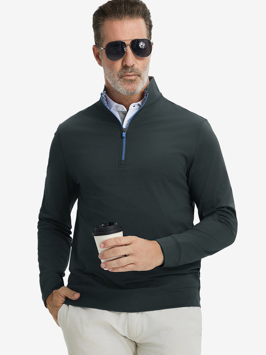 Front upper body view of model wearing lightweight golf quarter zip pullover in dark grey, relaxed fit.