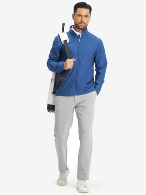 Full-body shot of model with golf bag on back wearing light grey water-resistant stretch heat-tech winter trousers