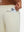 Close-up of iPhone partly inside pocket of beige soft sweatpants with 4 zipper pockets