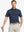 Model in NAVY STRIPE Golf Polo holding club — dynamic front half-body pose