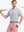 Model in LIGHT GREY STRIPE Golf Polo holding club — dynamic front half-body pose