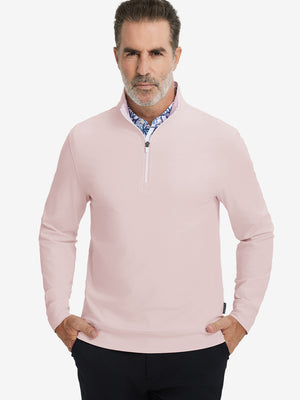 Front upper body view of model wearing lightweight golf quarter zip pullover in light pink, relaxed fit.