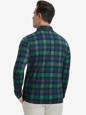 Back upper body view of the lightweight print polo in dark plaid, model turns slightly with relaxed pose.