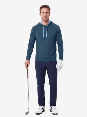  Full body model holding golf gear outdoors, heather midlayer golf hoodies in dark blue heather