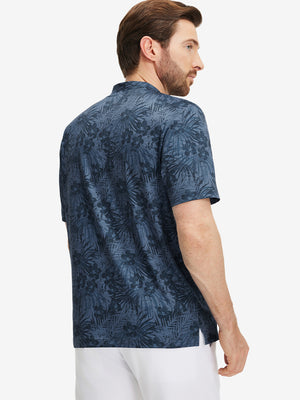 Back half-body of model in dark blue plant stretch printed collarless henley golf shirts
