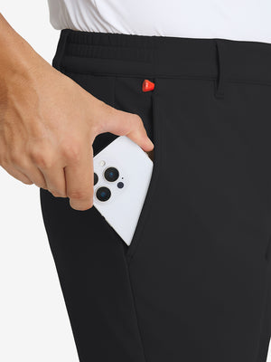 Close-up detail showing phone being placed in the pocket of black water-resistant stretch heat-tech winter trousers